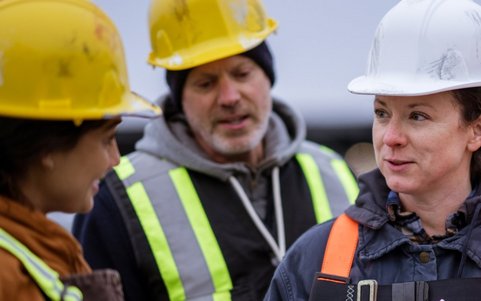 Construction workers discussing safety procedures on site