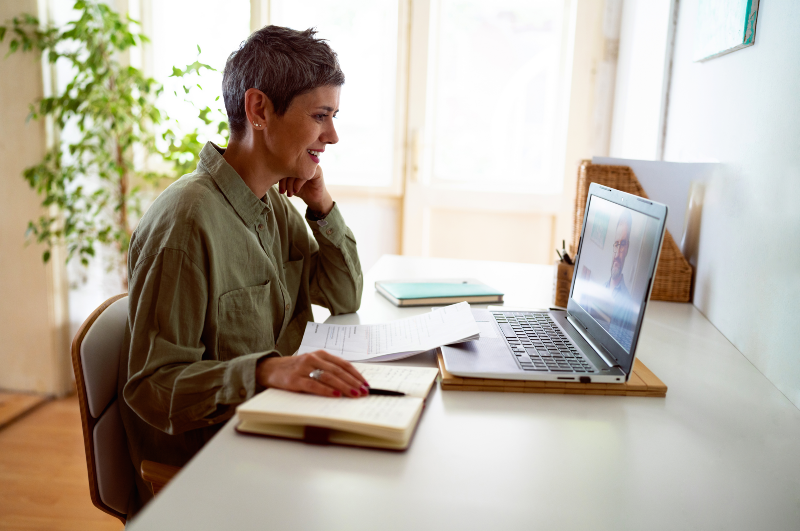 A woman completing online training on a laptop.